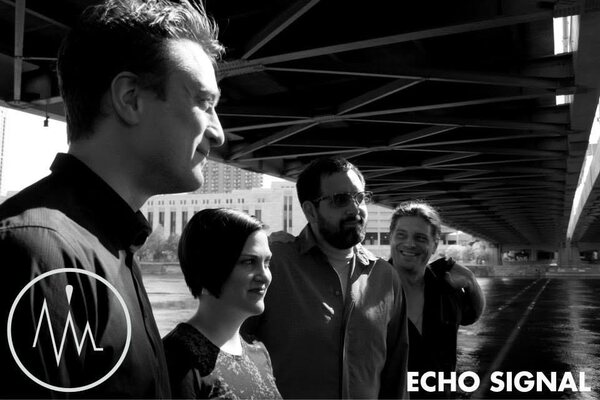 Black and white portrait of the 2014 line-up, including Rachel Westhoff and Ben Ortega, beneath a bridge in Minneapolis.