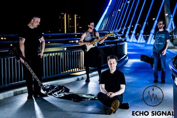 The 2016 line-up with Charles Sadler on a blue-lit bridge at night.