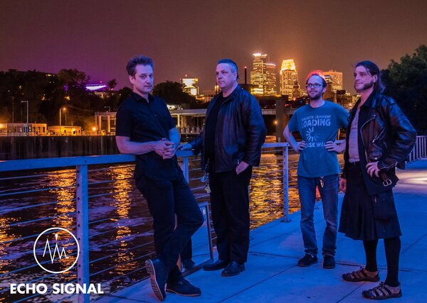 The 2016 line-up on the riverfront with the Minneapolis skyline behind them.