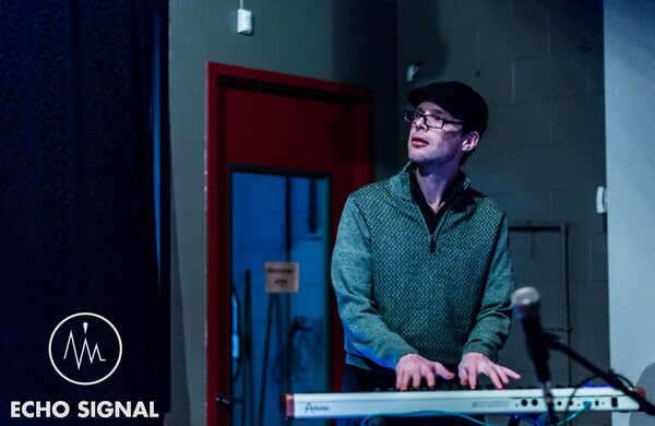 Charles Sadler playing keyboards on stage, 2017.